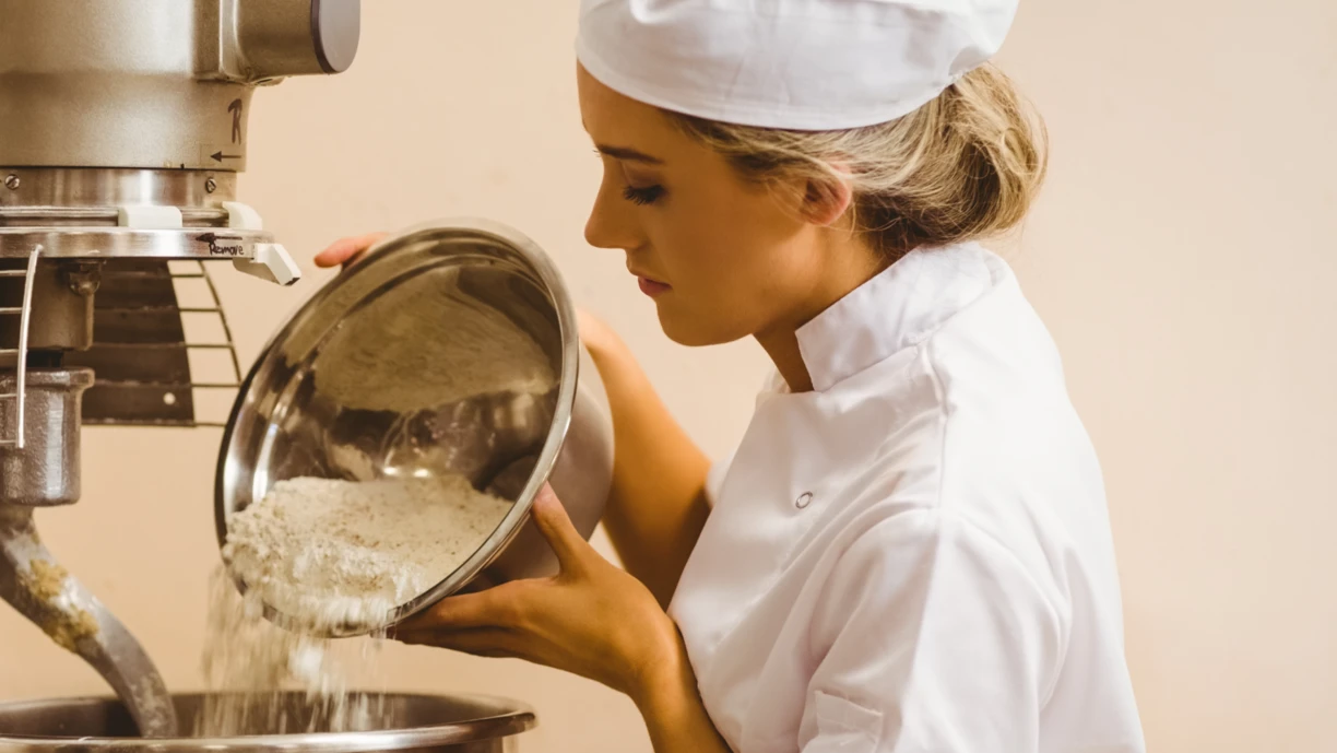 Woman in factory folding dough