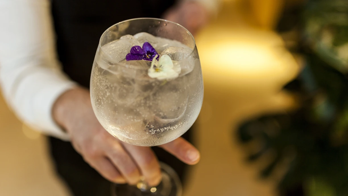 Waiter serving a gin and tonic