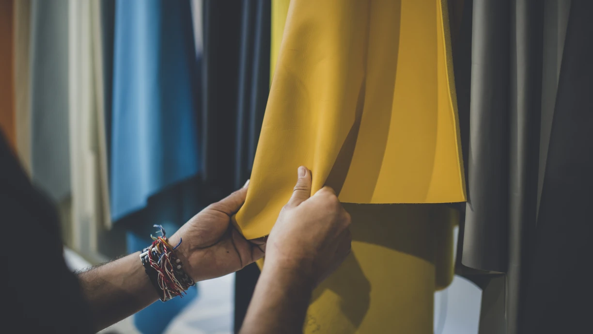 Woman hands feeling on yellow fabric 