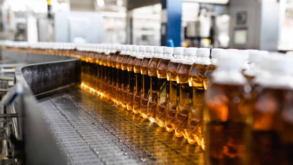 A juice factory conveyor belt with apple juice