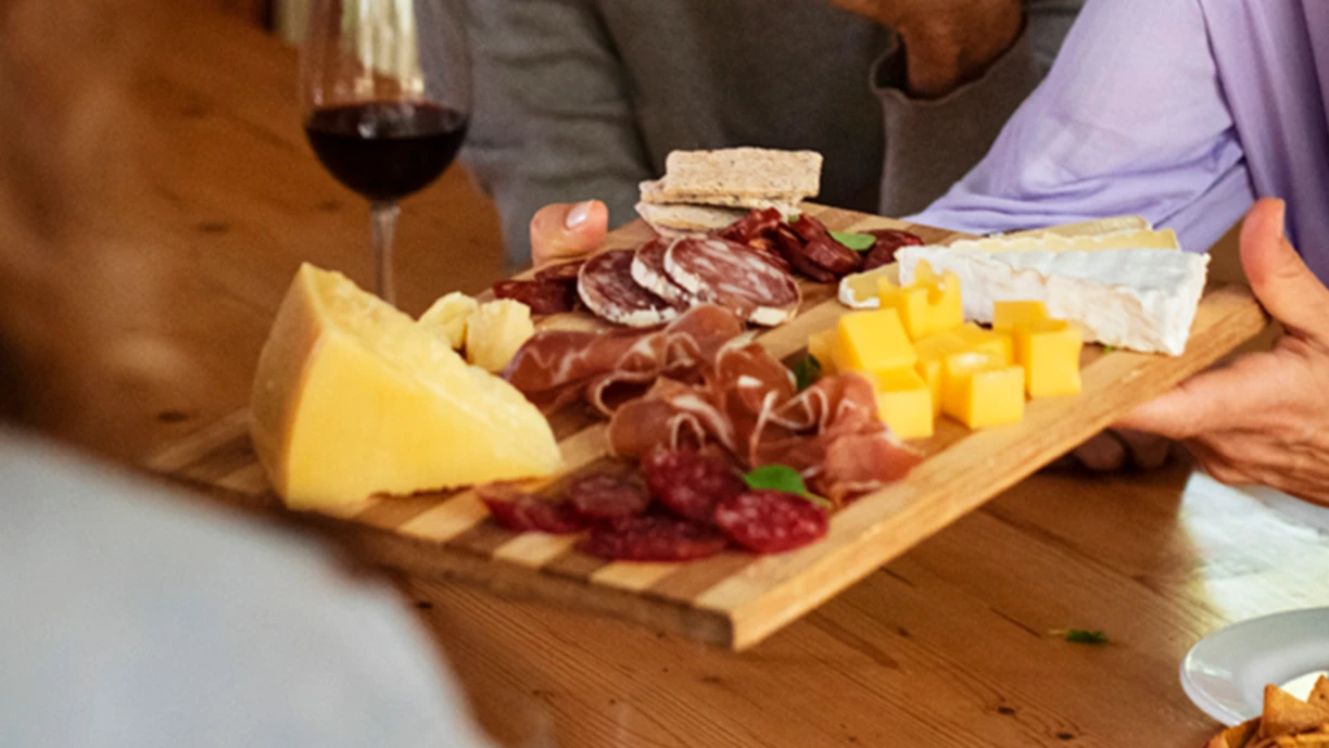 People charcuterie cheese wine inside 