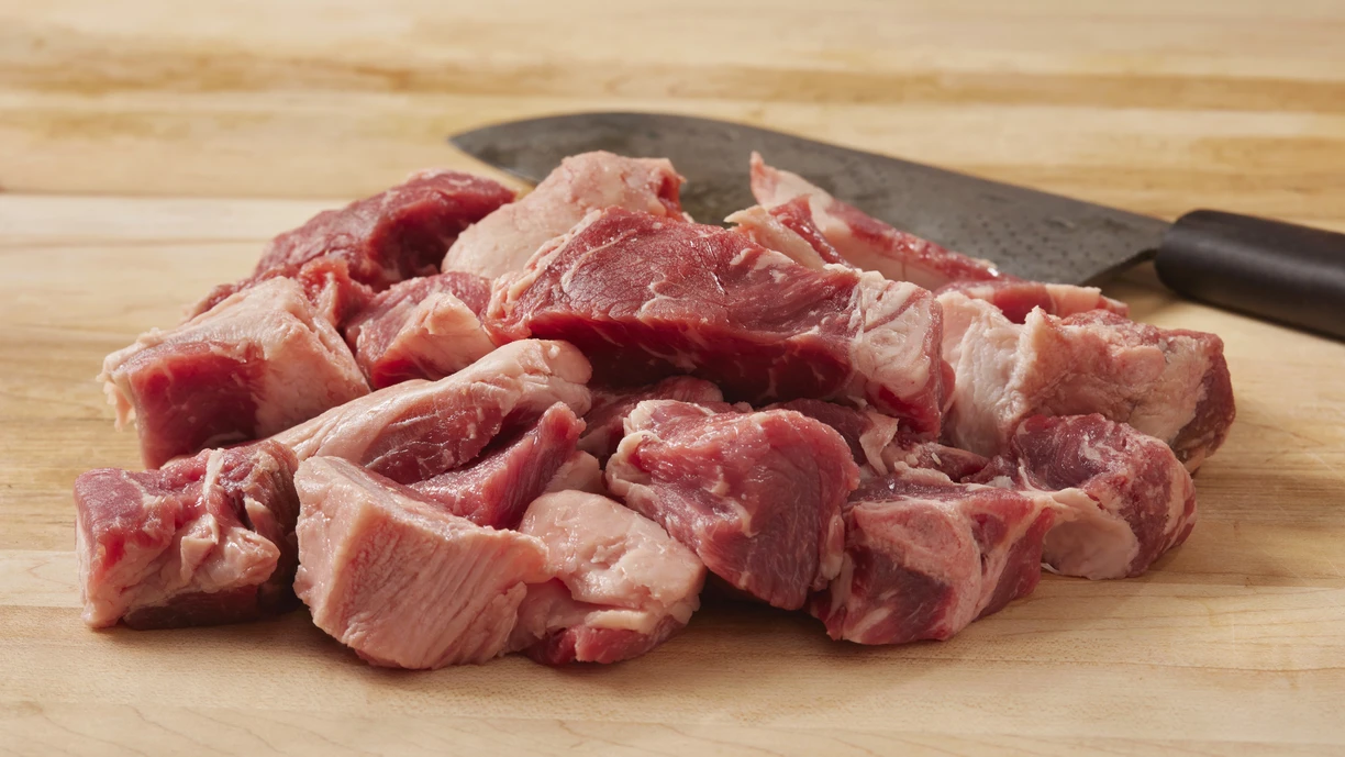 A chunk of raw meat on a cutting board