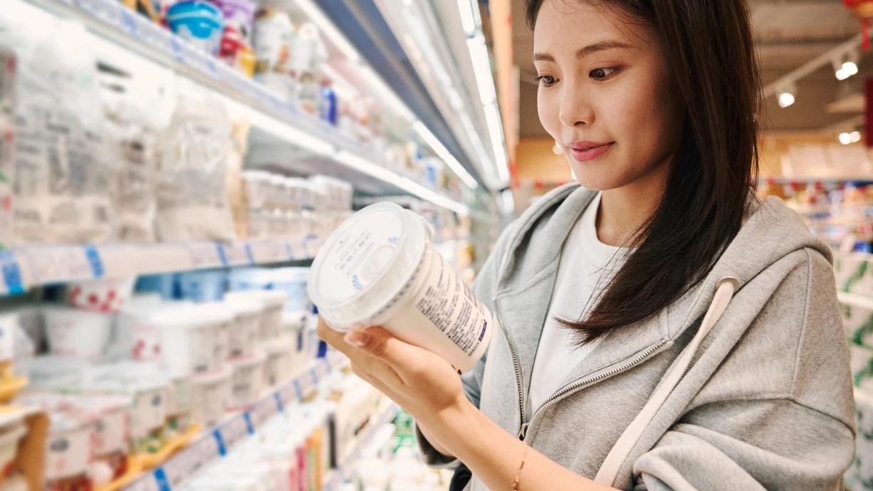 woman-shopping-checking-label-dairy