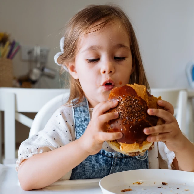 Girl enjoying a plant-based burger