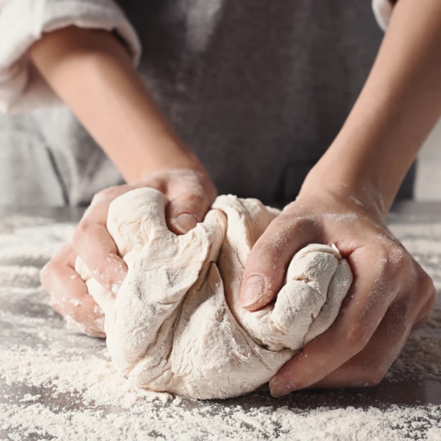 Closeup hands making dough 