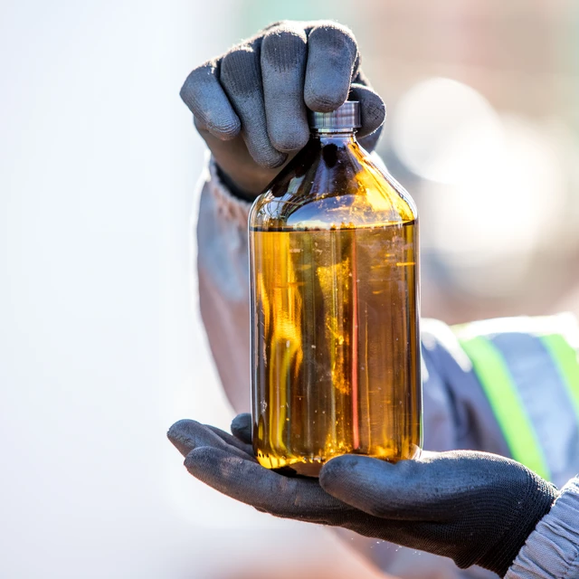 Worker_Holding_Bottle