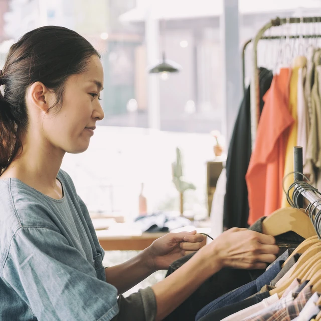 Woman looking at clothes on rack
