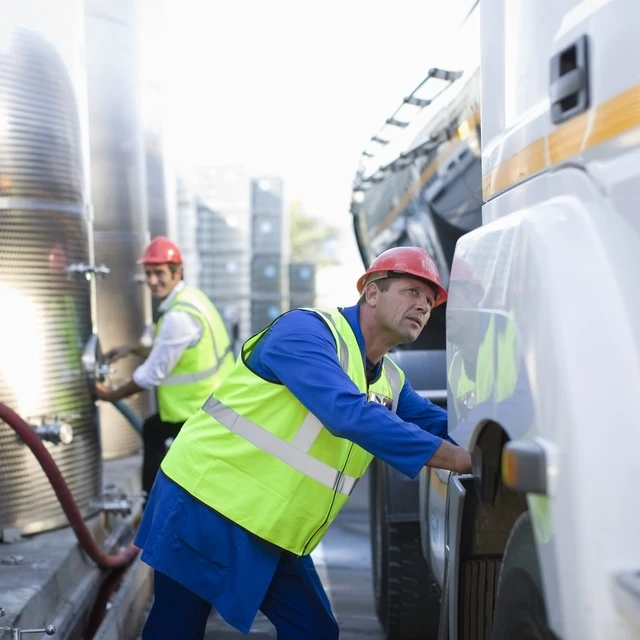 Workers refuelling truck