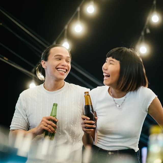 Friends laughing drinking beer