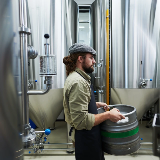 A man carrying large beer fsutage