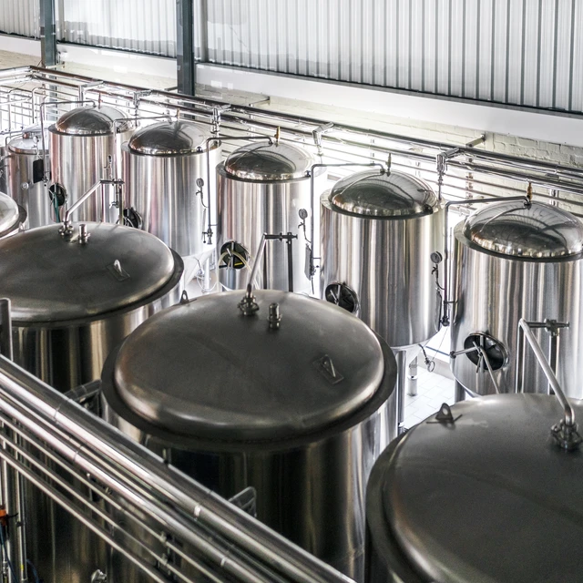 High angle view of metallic vats in brewery