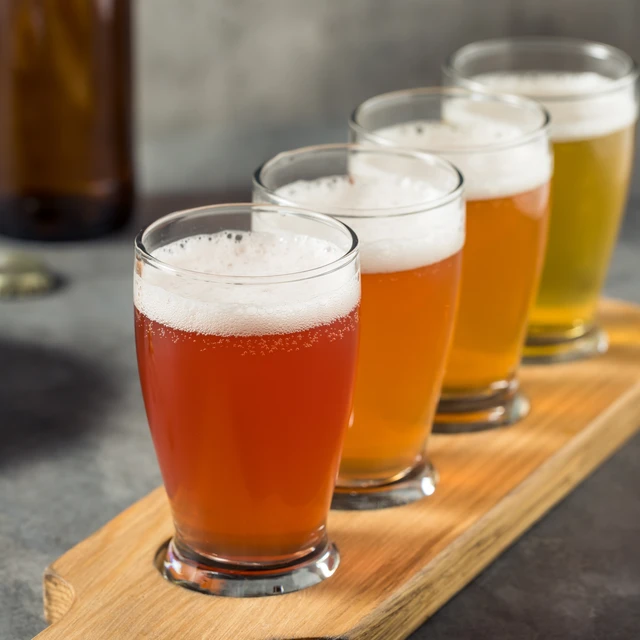 A row of different types of beer in a high glass