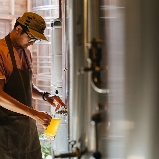 Brewer taking a beer sample
