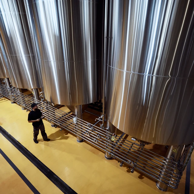 Fermentation tanks seen from above with workers
