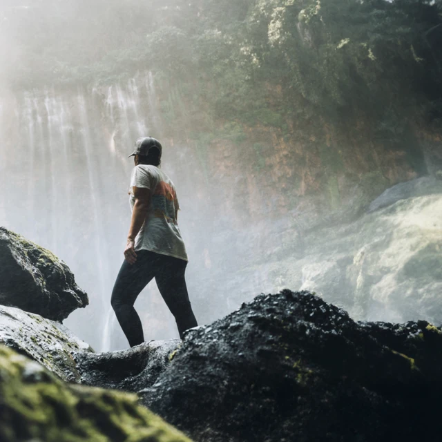 Man_in_the_jungle_looking_at_a_waterfall__