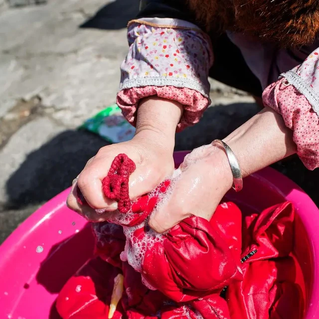 person hand-washing clothes