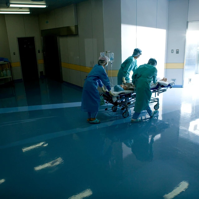 Doctors pushing patient on trolley
