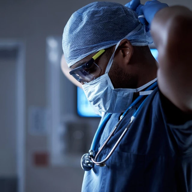 Shot of a surgeon putting on his surgical mask in preparation for a surgery