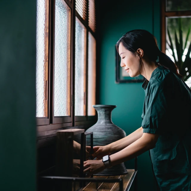 asian-woman-decorating-living-room