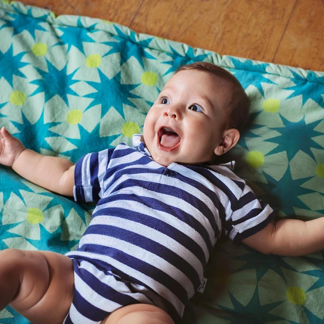 baby happy on blanket