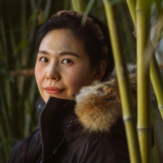 woman next to bamboo