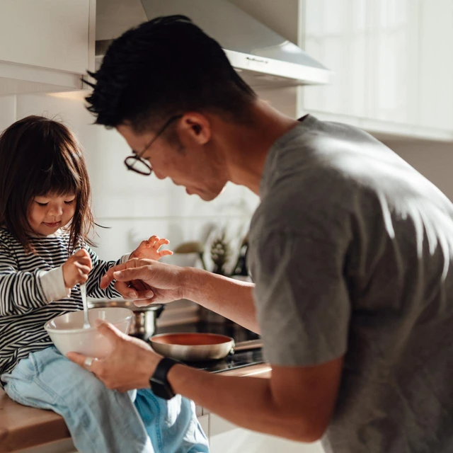 father and daughter cooking