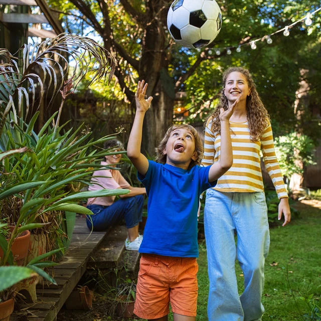 siblings playing in garden