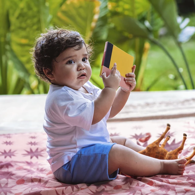 toddler boy with book
