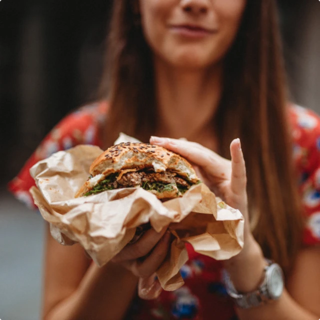 Woman-holding-burger