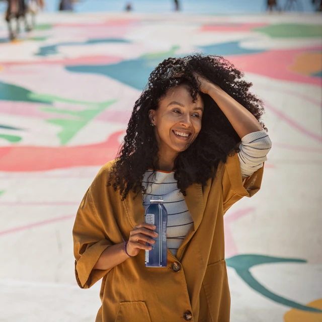 woman-drinking-yoghurt-outside-novonesis