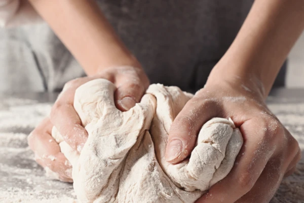 Closeup hands making dough 