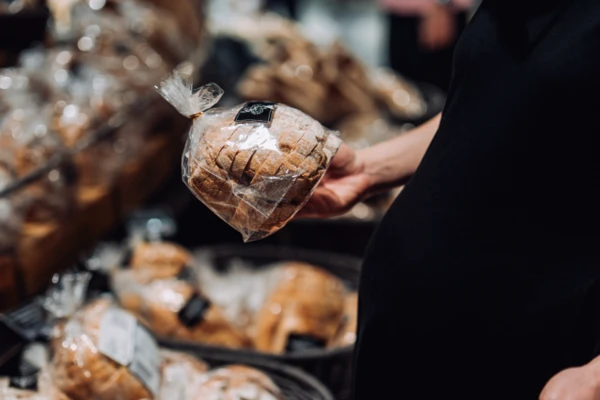 Woman shopping for packaged bread