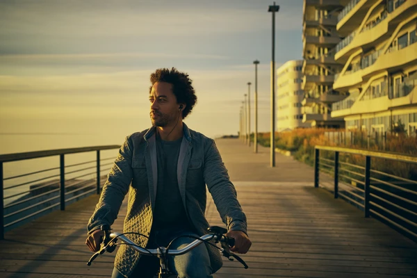 Man biking on a bridge 