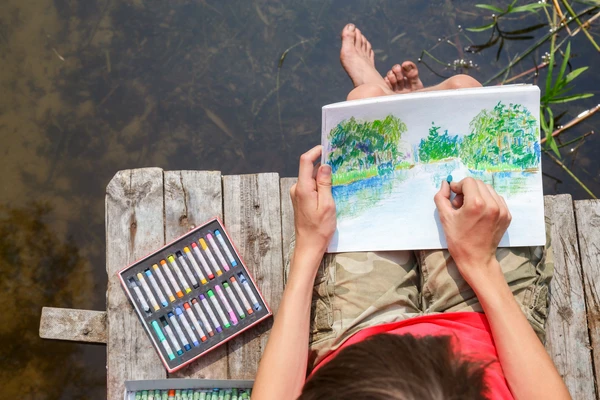 boy drawing on a paper