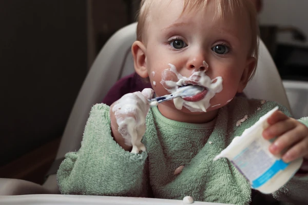 Kid eating yogurt