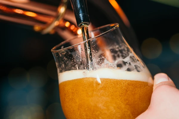 Beer poured in a glass from tap