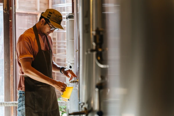 Brewer taking a beer sample