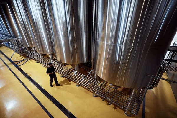 Fermentation tanks seen from above with workers