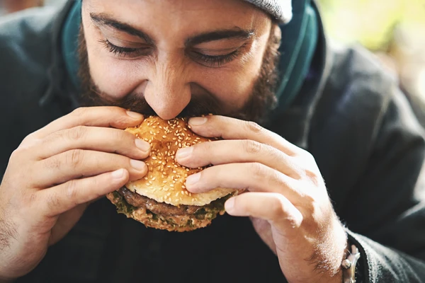 man eating burger
