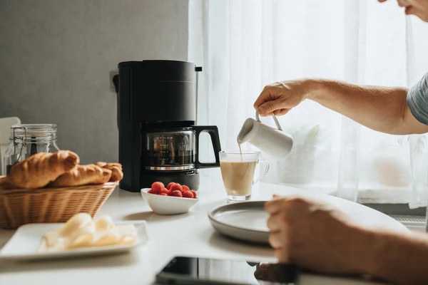 pouring milk in coffee