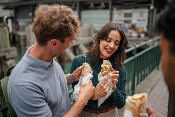 Young adults enjoying delicious food together in sunny Sydney Australia