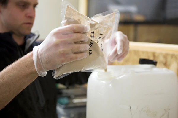 brewery technician mixing powdered yeast