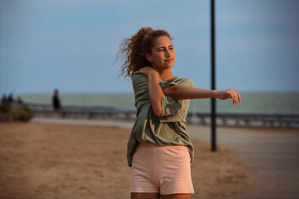 girl stretching at beach