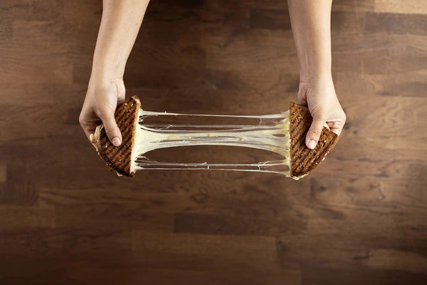 hand pulling cheese toasty apart