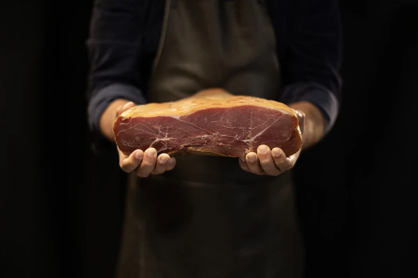 Hands holding piece of meat