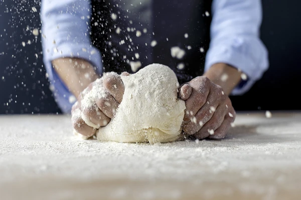 Hands kneading bread