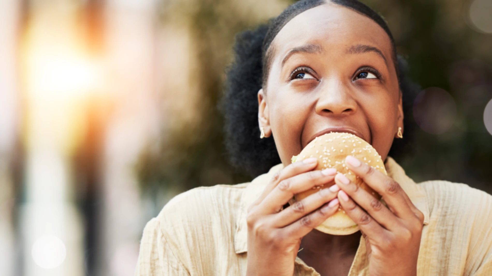 Woman_enjoying_a_tasty_burger_bun