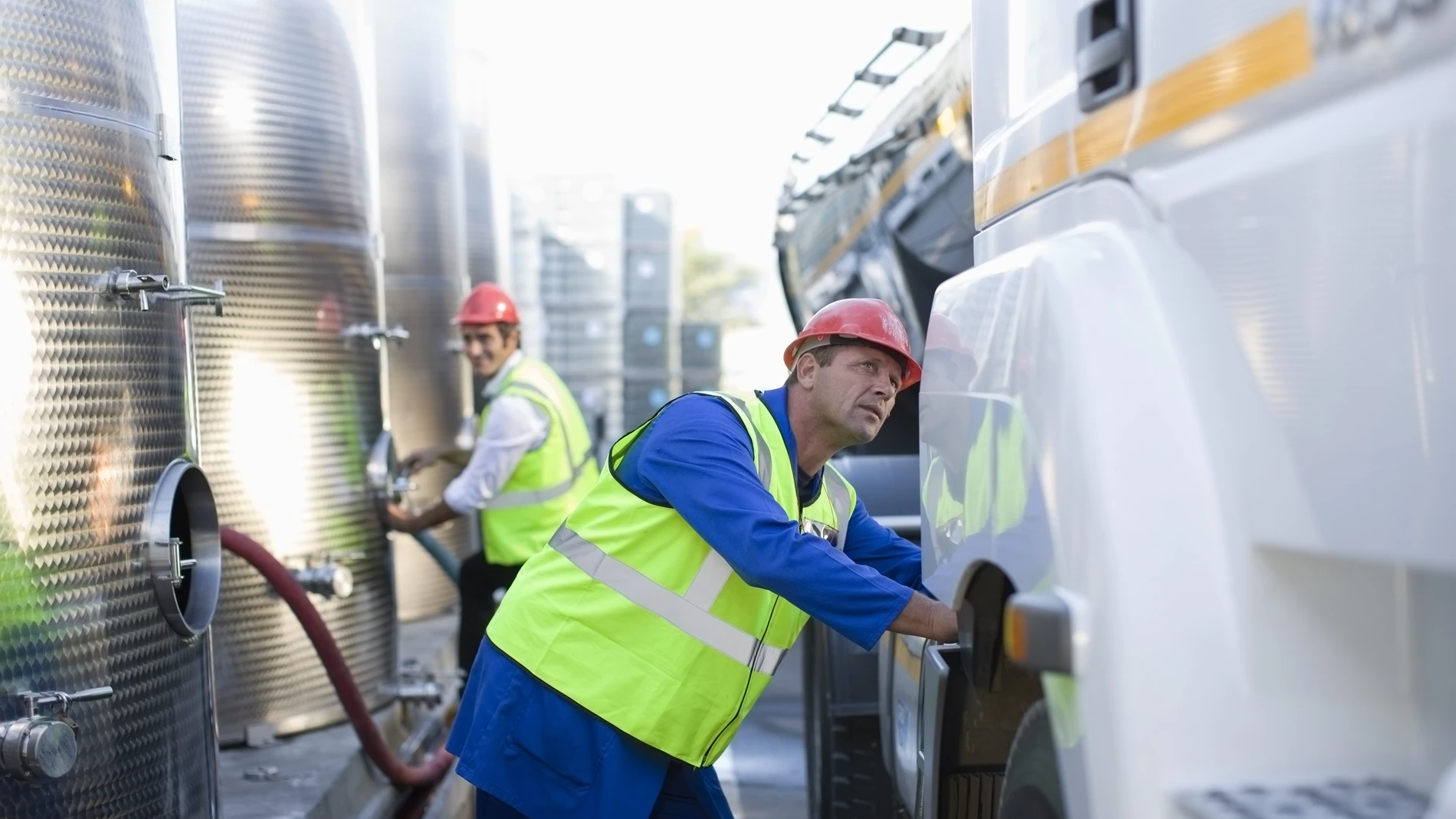 Workers refuelling truck