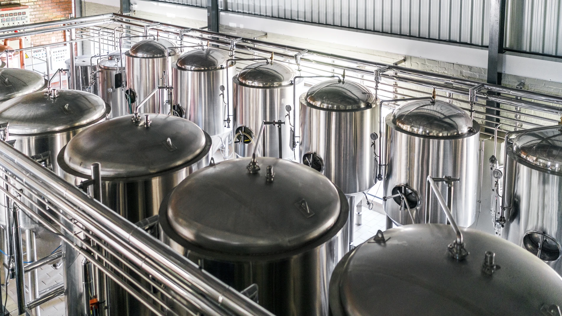 High angle view of metallic vats in brewery