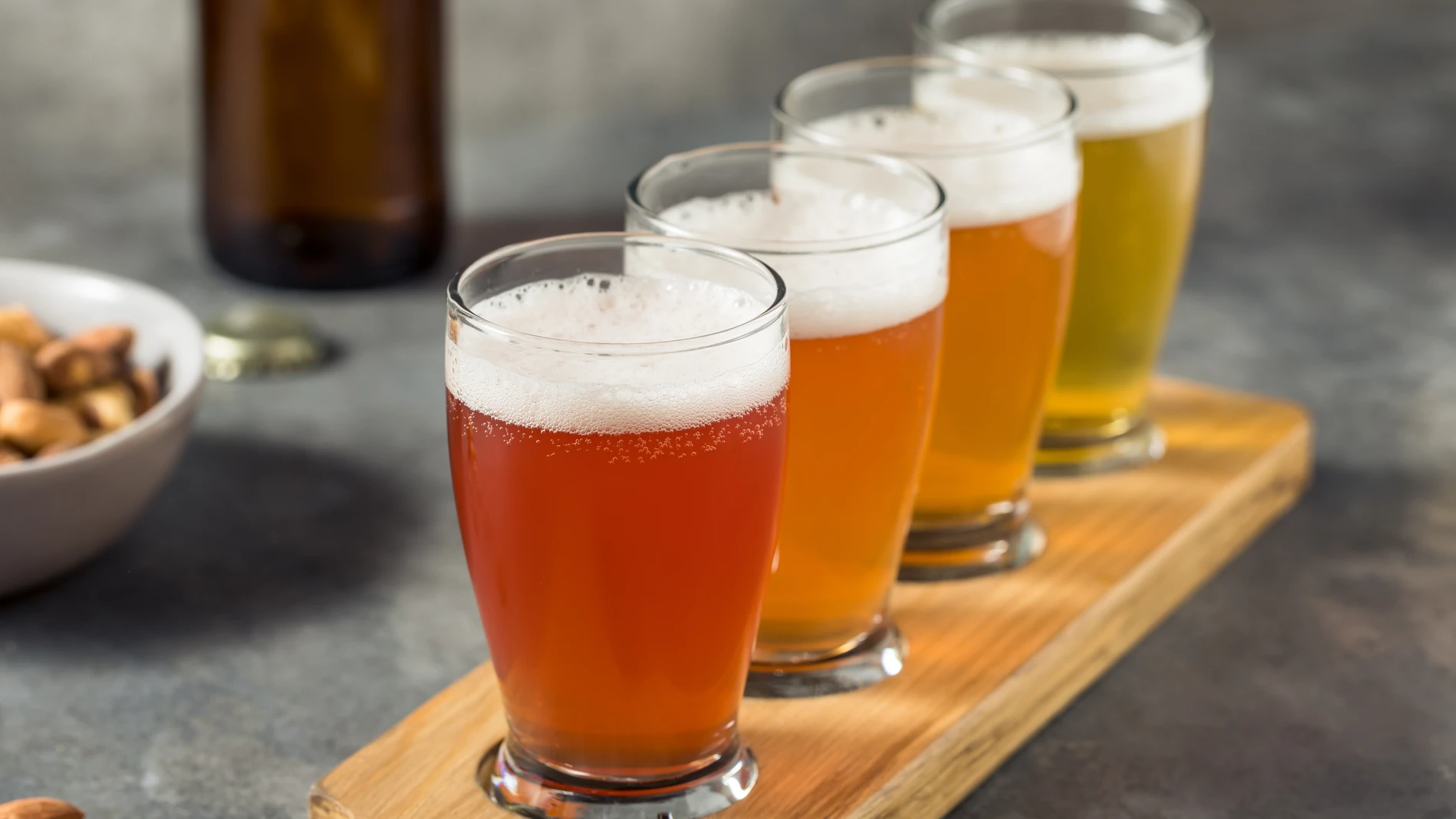 A row of different types of beer in a high glass